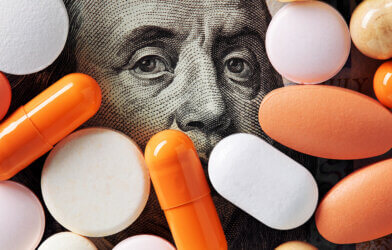 Hundred dollar bill surrounded by pills, drugs