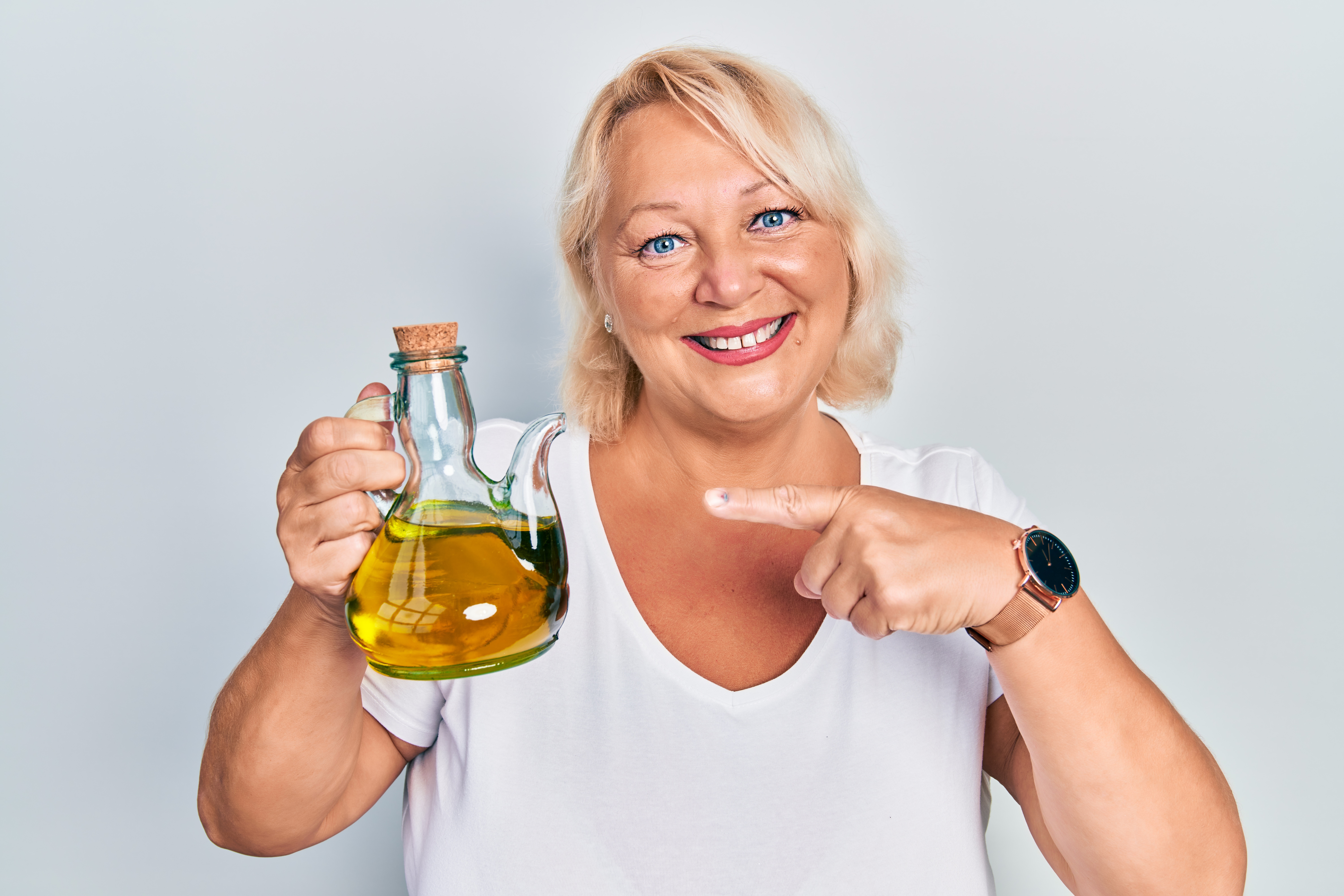 Woman holding an olive oil carafe