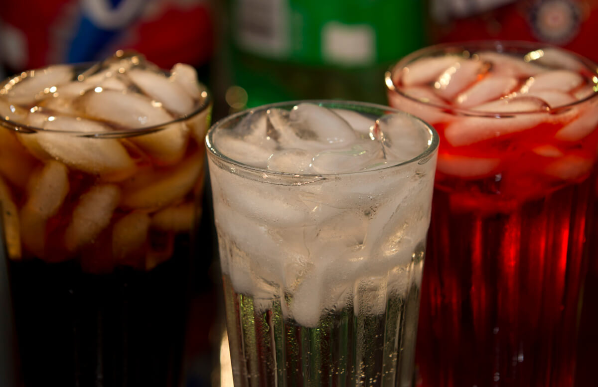 Soft drinks in glasses with bottles