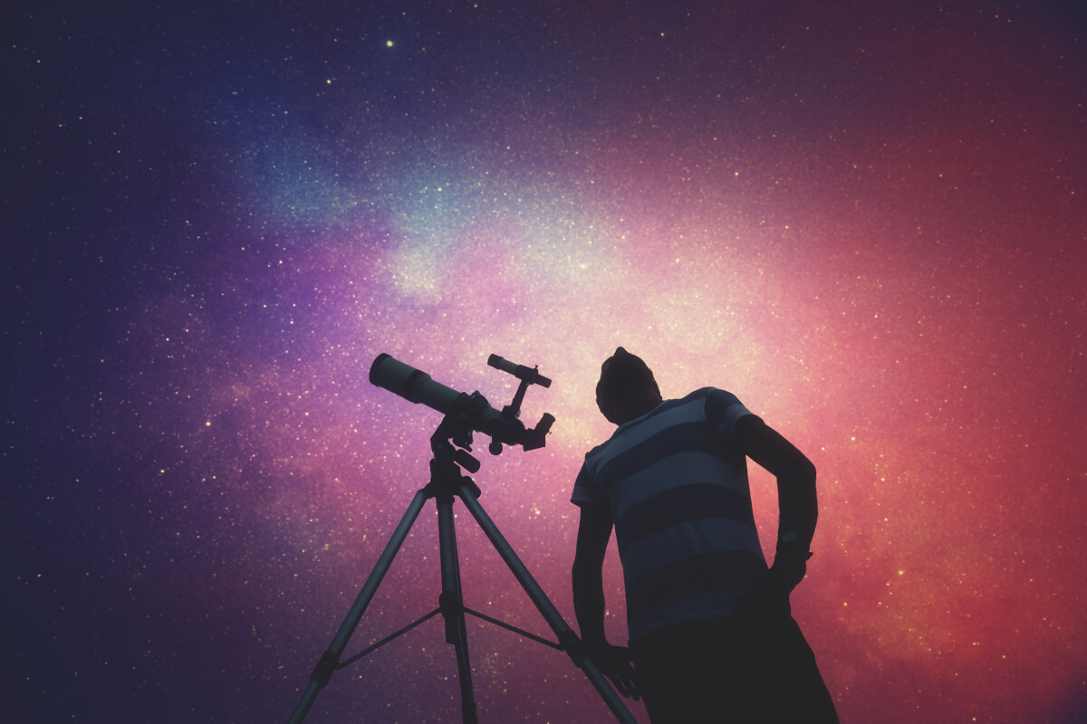A man stargazing with a telescope