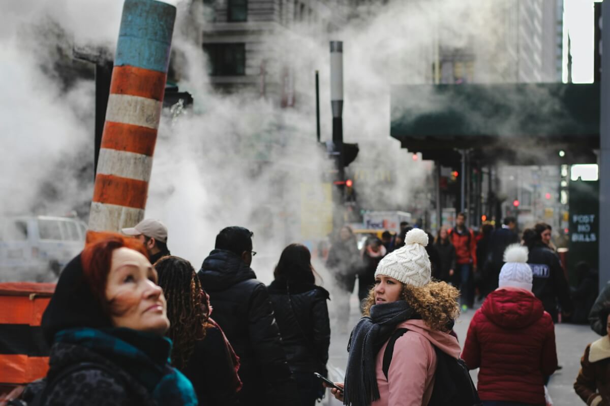 people standing in city smog steam