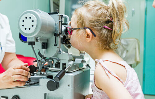 Young girl has a vision test at the eye doctor