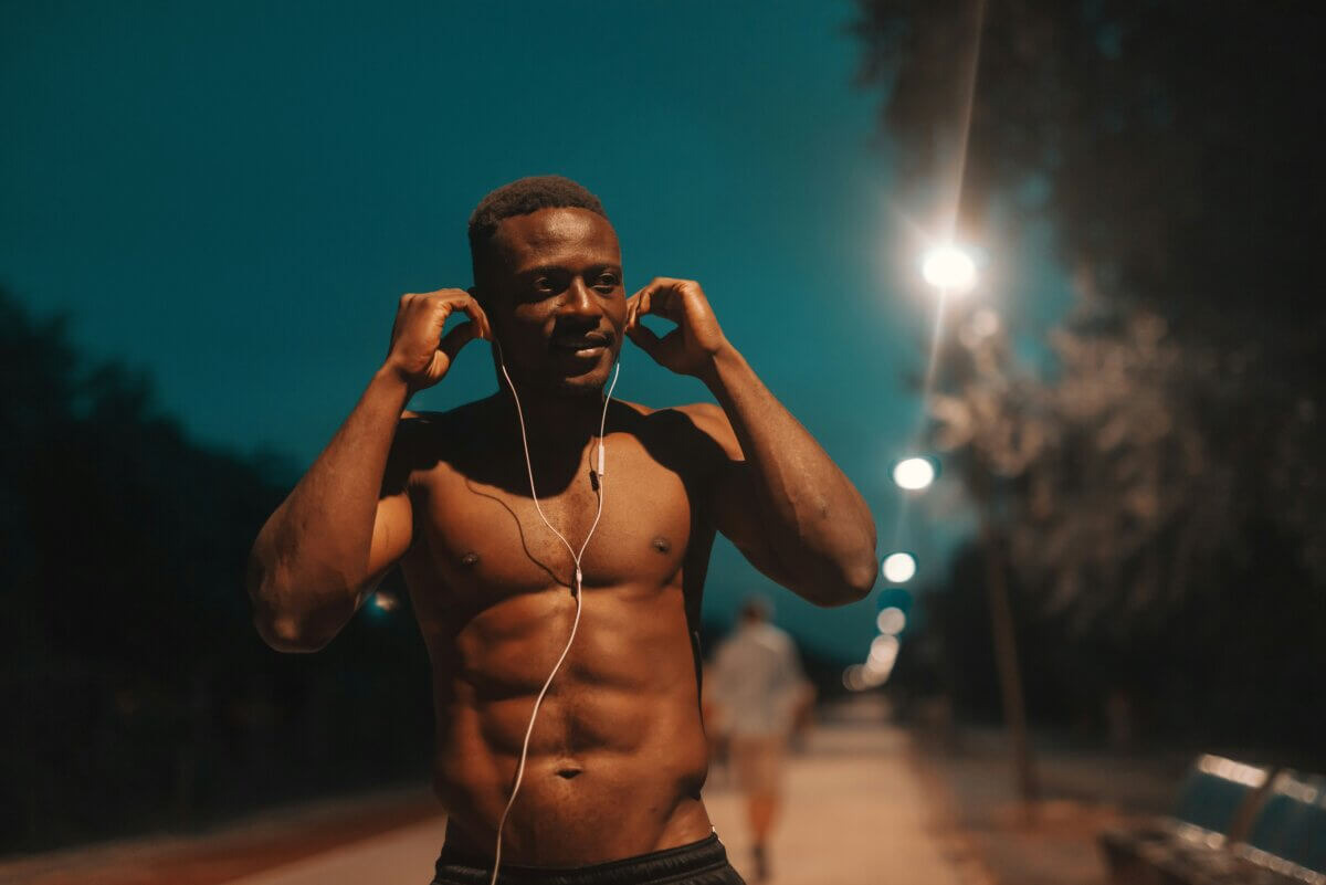 Man with six-pack abs working out at night