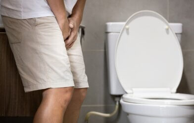 Man holding himself from overactive bladder or urinary tract infection