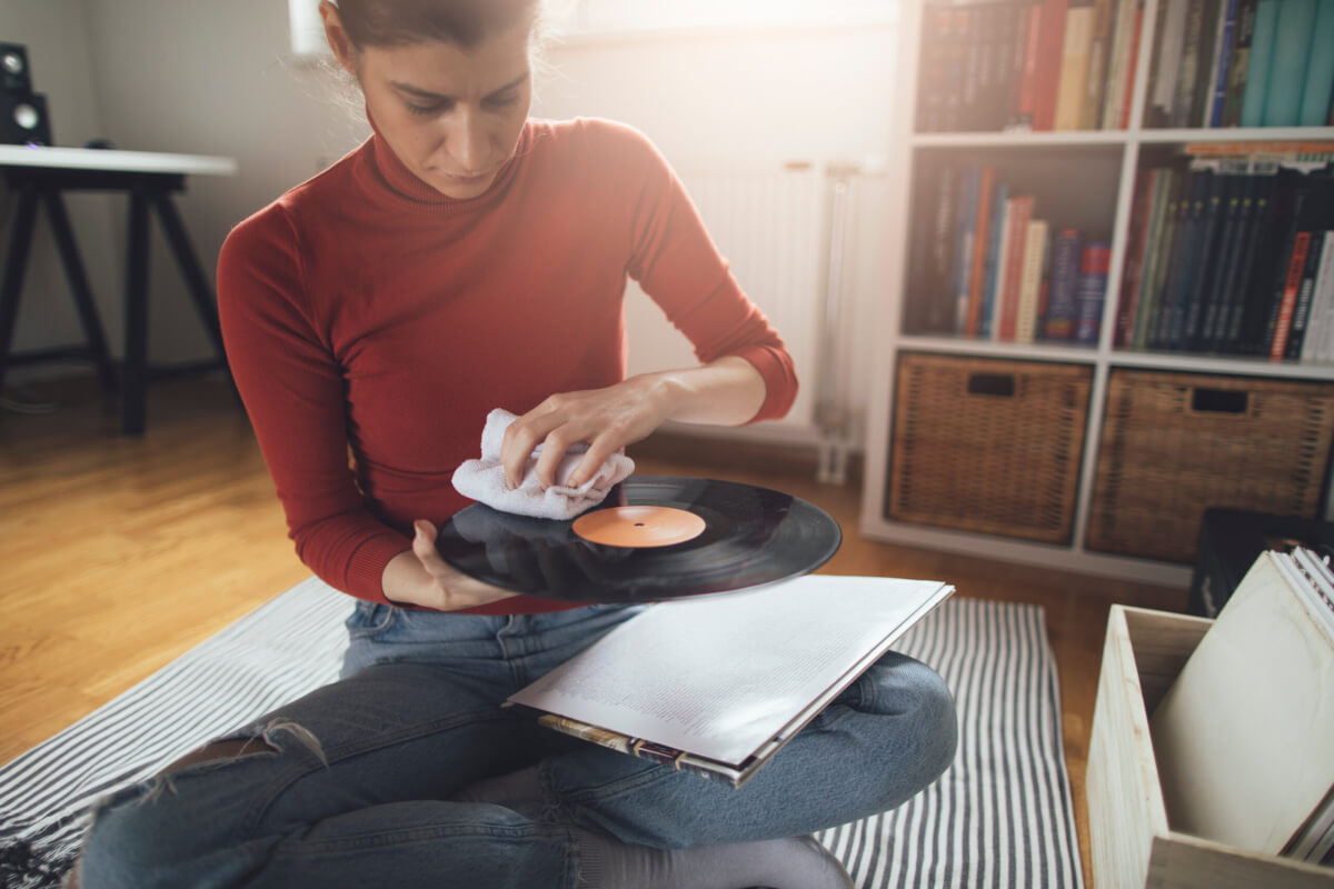 Woman cleaning a vinyl record album