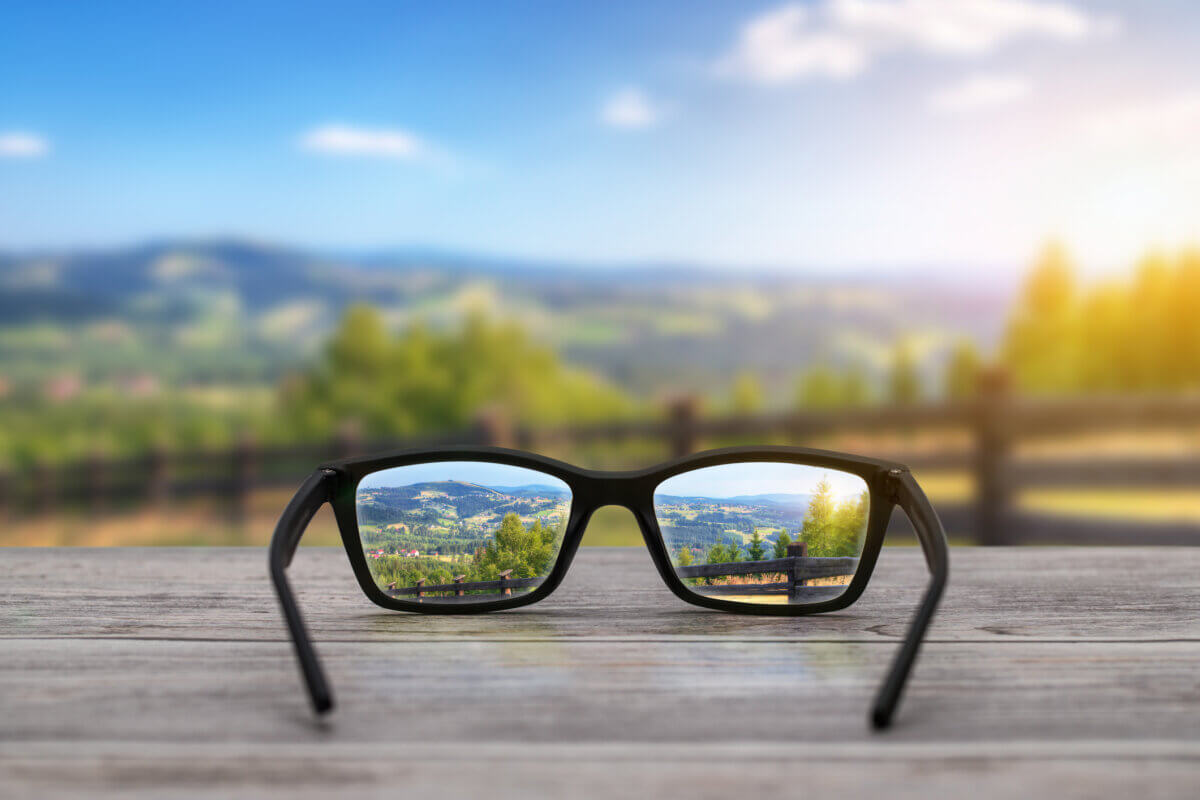 Glasses for someone with myopia (nearsightedness) in front of landscape
