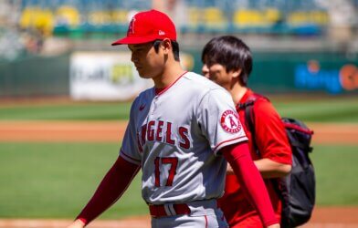 Los Angeles Angels DH Shohei Ohtani and translator Ippei Mizuhara walk on the field before a game against the Oakland Athletics at the Oakland Coliseum.