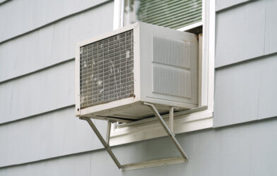 old air conditioner installed in house window