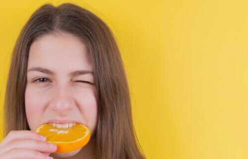 woman eating whole orange