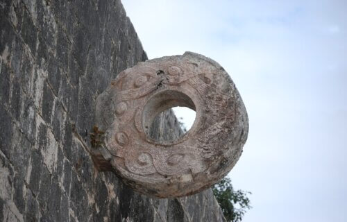 A decorative ring made from carved stone is embedded in the wall of a ballcourt in the ancient Maya city of Chichen Itza.