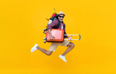 A man jumping with suitcases
