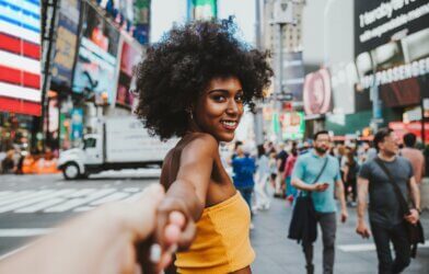 A woman leading someone through New York City