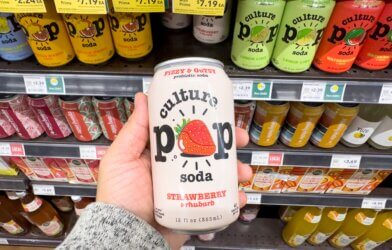 Someone holding a can of Culture Pop probiotic soda in a store