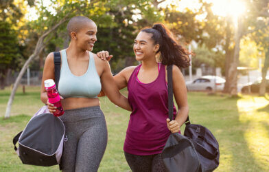 Women smiling after exercising, finishing a good workout