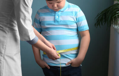 Doctor measuring overweight boy