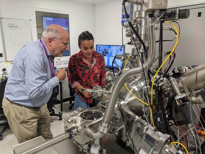 Co-authors (left) Prof David Jamieson (University of Melbourne) and (right) Dr Maddison Coke (University of Manchester) inspect the P-NAME focused ion beam system at the University of Manchester used for the silicon enrichment project.