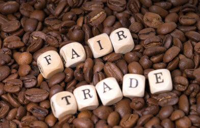 Fair-Trade spelled out in blocks over coffee beans