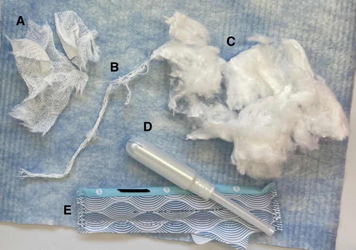 Fig. 1. A tampon separated into its components, including the (A) non-woven outer covering, (B) withdrawal string, (C) inner absorbent core, (D) applicator, and (E) wrapper. 